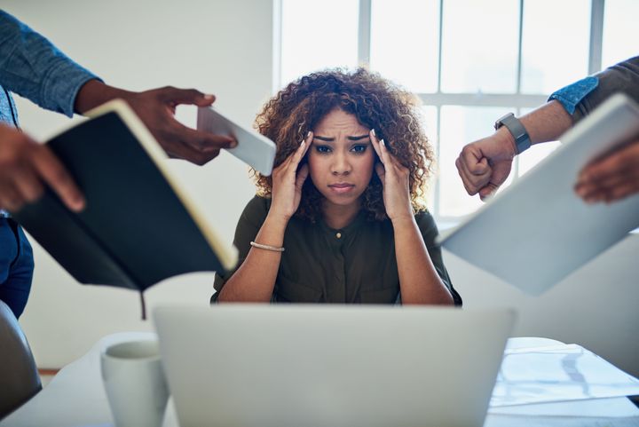 A women overwhelmed by work should learn how to deal with stress