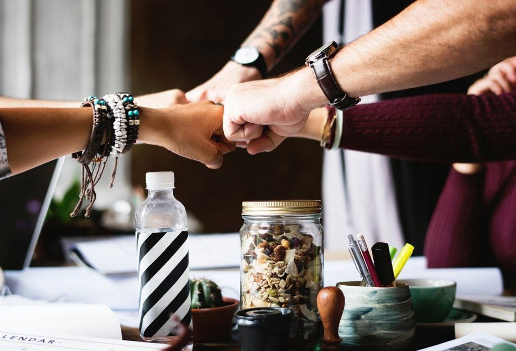 people celebrating the World Compliment Day with a fist bump