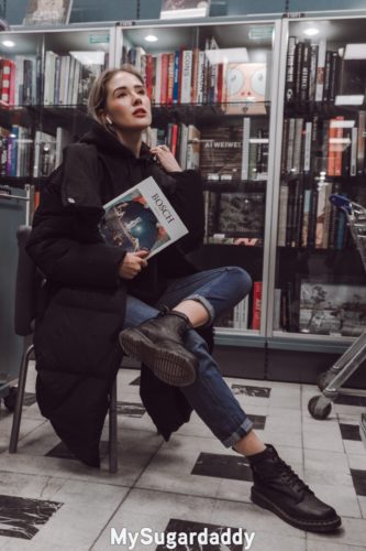 sapiosexual girl posing with book in library