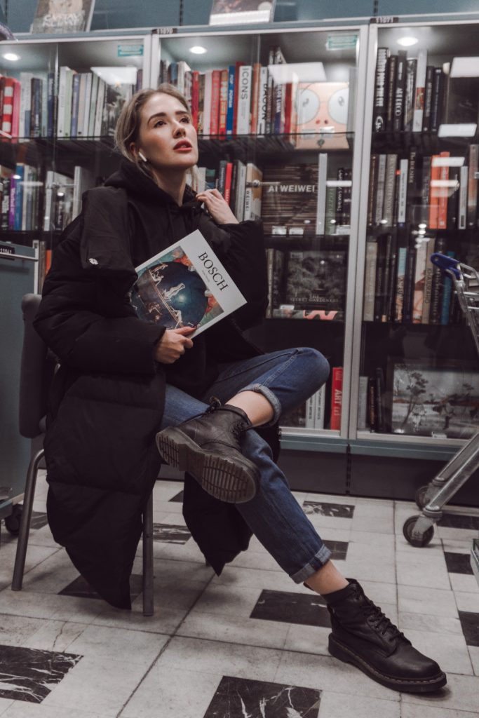 sapiosexual girl posing with book in bookshop