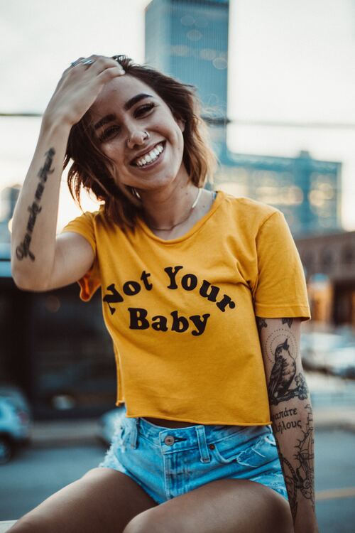 Girl wearing shirt that reads "not your baby"