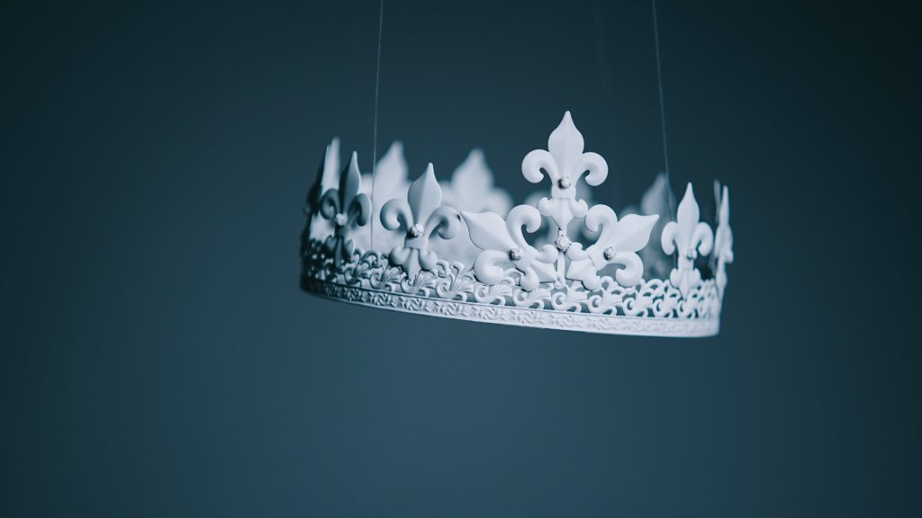 white crown hung by transparent threads