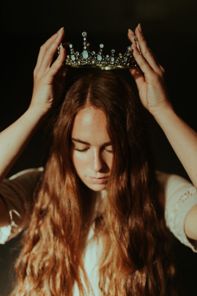 girl putting on a crown