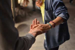 woman reaching for man's hand