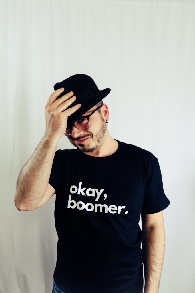 millennial wearing a shirt that reads "okay, boomer"