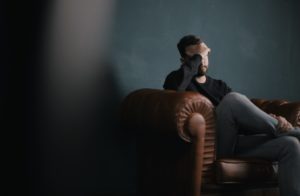 sad man on leather couch