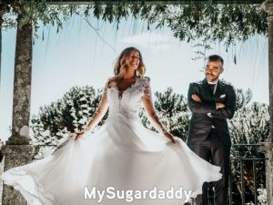 romantic sugar daddy looking proudly at his bride