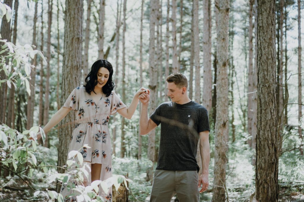 cute cuffing couple walking in a snow-covered forest