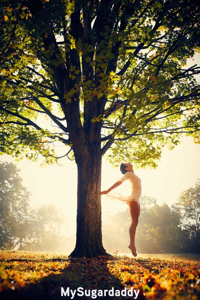 woman feeling the effects of oneness under a tree