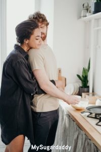new relationship: sugar baby enjoying her time with her sugar daddy in kitchen